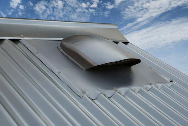 Low profile roof vent on mental roof